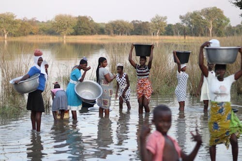 Children playing in water that is also used for drinking and bathing